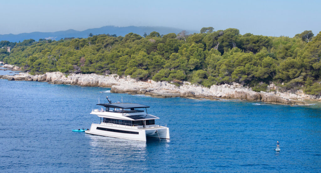Solar-powered catamaran sailing in turquoise waters
